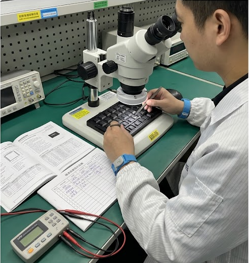 IQC technician inspecting precision ICs and automotive-grade components under microscope